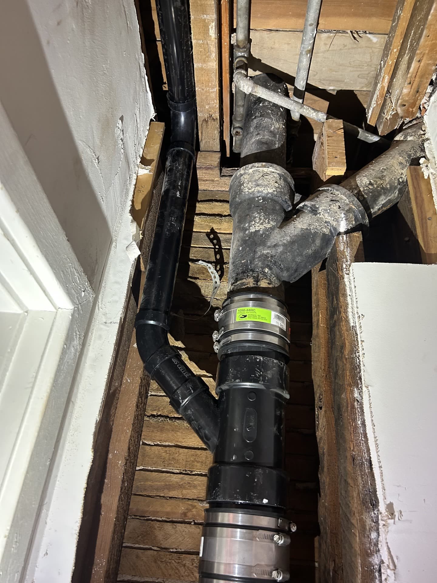 Replacement plumbing installed behind an opened wall