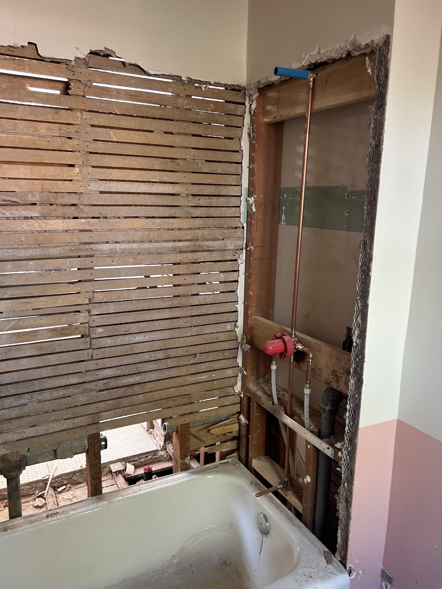 Guest room wall opened to the studs during plumbing and electrical work